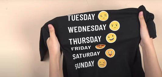 This covered image shows a black T-shirt with emoji designs.