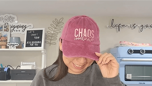 This cover photo shows Jessica wearing a DIY hat with "CHAOS Coordinator" printed on it. Her DIY works and machines are shown in the background.